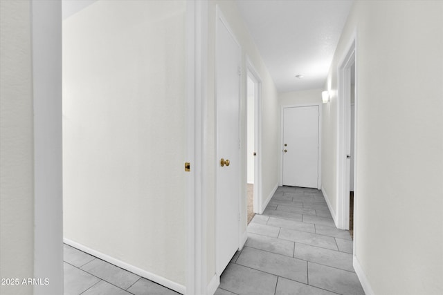 corridor featuring light tile patterned flooring