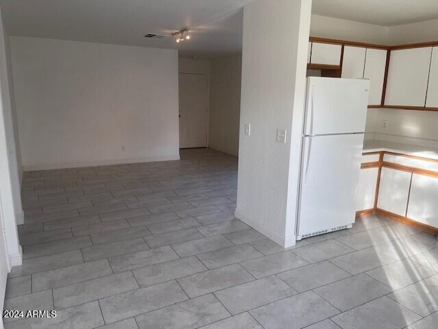 kitchen with white cabinets and white refrigerator