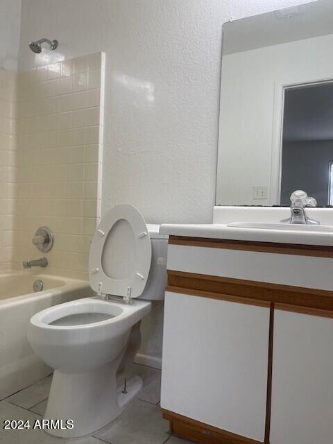 full bathroom with tile patterned flooring, vanity, toilet, and tiled shower / bath