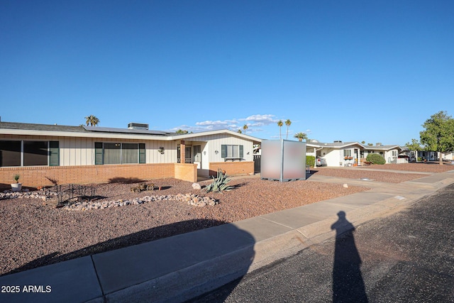 single story home with solar panels