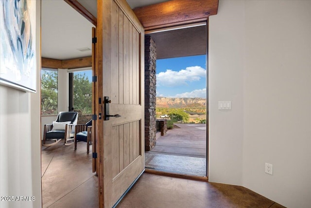 doorway to outside featuring concrete flooring and a mountain view