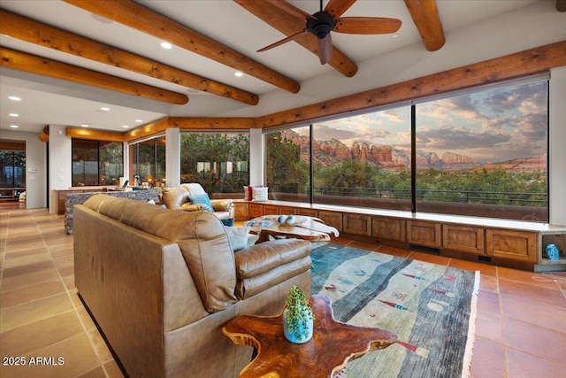 sunroom / solarium with ceiling fan, a healthy amount of sunlight, and beam ceiling