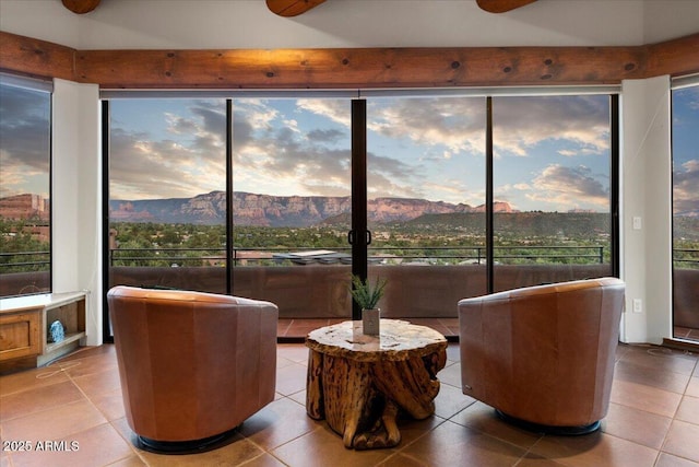 living area featuring a mountain view and light tile patterned floors