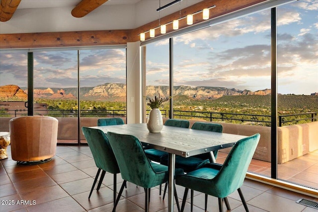 sunroom / solarium featuring a mountain view