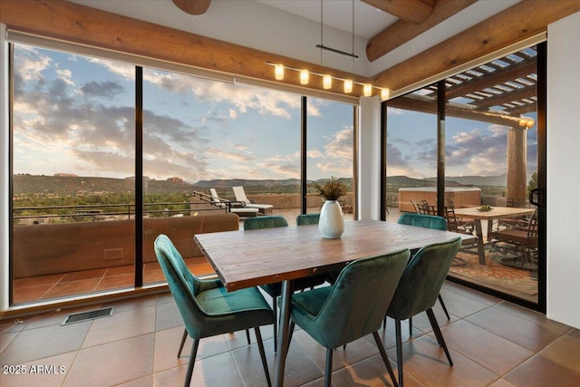 sunroom / solarium with plenty of natural light and a mountain view