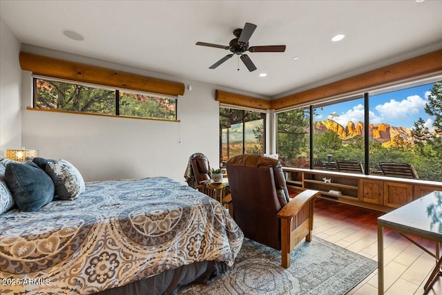 bedroom with ceiling fan and hardwood / wood-style floors