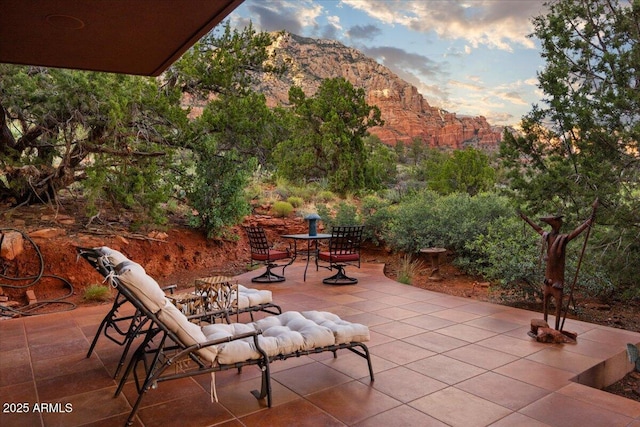 patio terrace at dusk with a mountain view