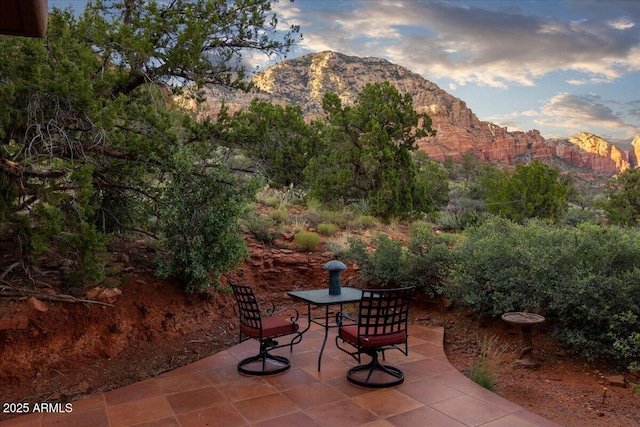 patio terrace at dusk with a mountain view