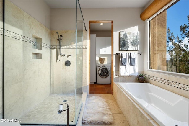 bathroom featuring washer / clothes dryer, tile patterned floors, independent shower and bath, and plenty of natural light