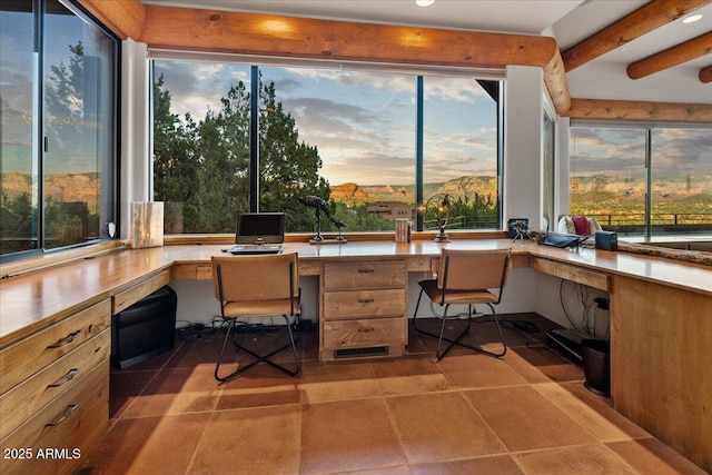 home office featuring built in desk and light tile patterned floors