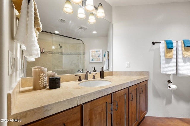 bathroom featuring an enclosed shower and vanity