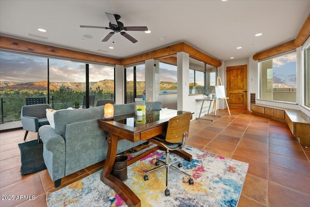 sunroom featuring ceiling fan and a wealth of natural light