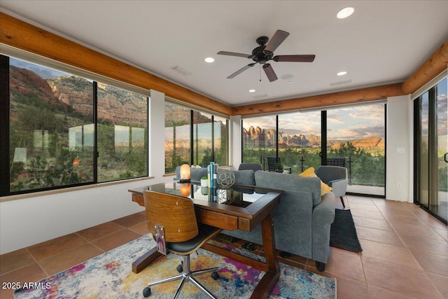 sunroom featuring ceiling fan and a wealth of natural light