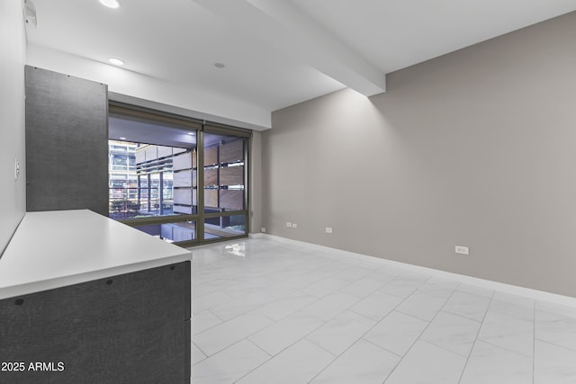 unfurnished room with beam ceiling, recessed lighting, and baseboards