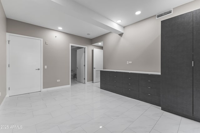 spare room featuring recessed lighting, visible vents, marble finish floor, and baseboards