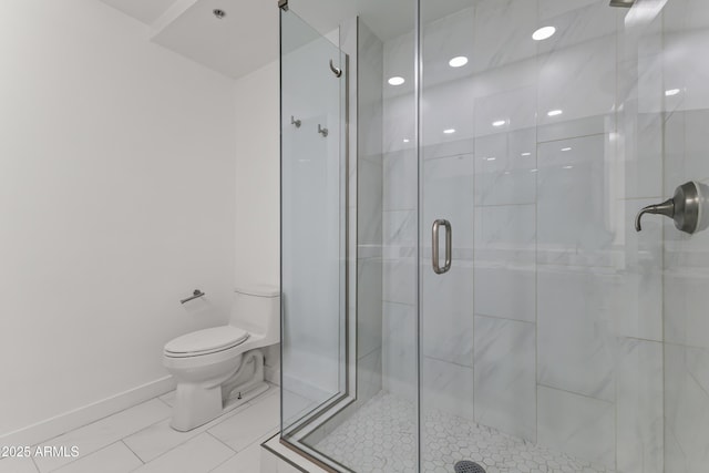 full bath with a shower stall, toilet, and baseboards