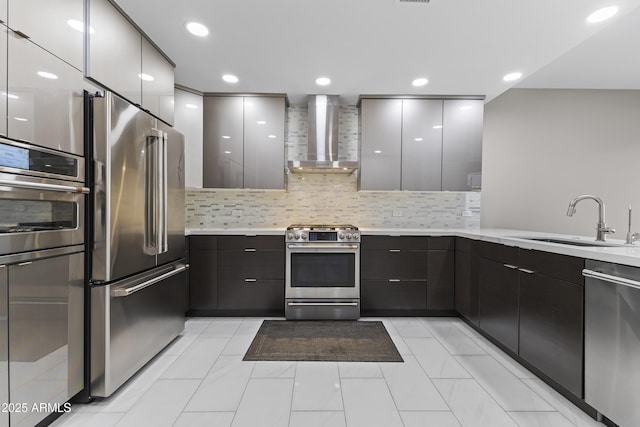 kitchen featuring a sink, stainless steel appliances, wall chimney exhaust hood, and modern cabinets