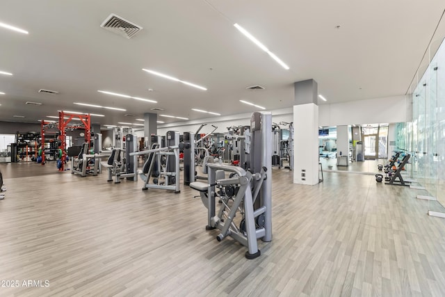 workout area with wood finished floors and visible vents