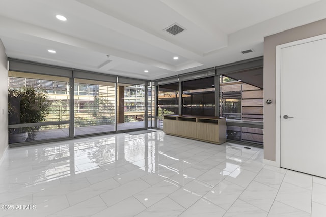 unfurnished room with floor to ceiling windows, recessed lighting, and visible vents