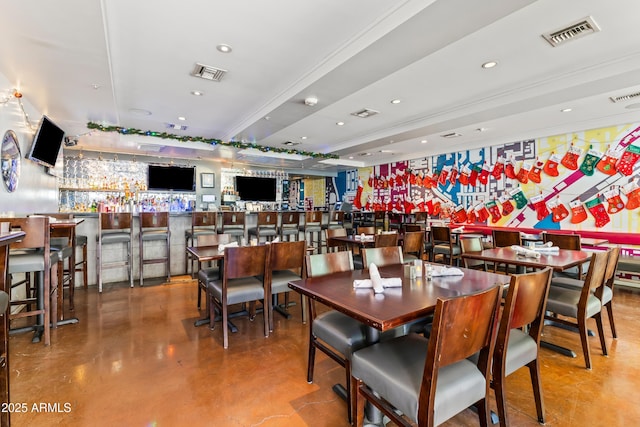 dining space with a community bar, recessed lighting, and visible vents