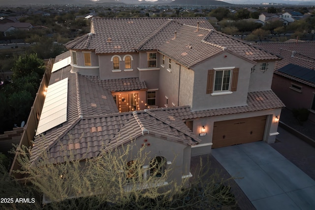 mediterranean / spanish home featuring a garage