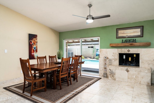 2301 E Sunnyside Dr, Phoenix, AZ 85028 - dining space featuring a ceiling fan, tile patterned flooring, and a tile fireplace
