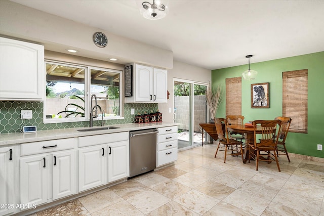 2301 E Sunnyside Dr, Phoenix, AZ 85028 - kitchen with stainless steel dishwasher, a sink, backsplash, and light countertops
