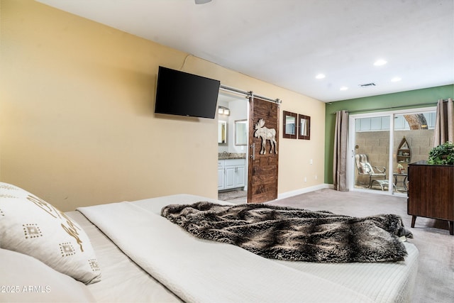 2301 E Sunnyside Dr, Phoenix, AZ 85028 - bedroom with access to exterior, light colored carpet, a barn door, ensuite bathroom, and recessed lighting