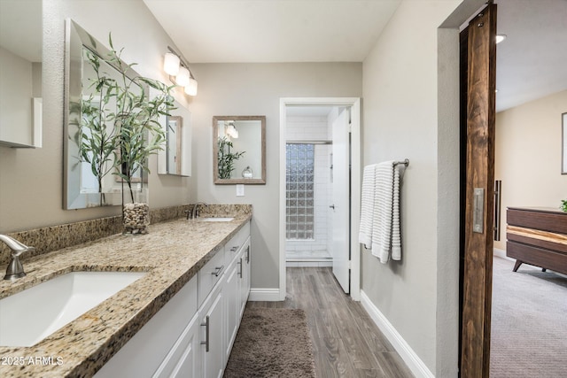 2301 E Sunnyside Dr, Phoenix, AZ 85028 - bathroom with double vanity, wood finished floors, and baseboards