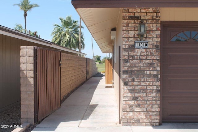 view of home's exterior featuring a garage and brick siding