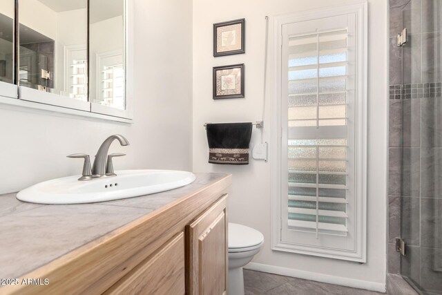 full bath with a shower with shower door, vanity, and toilet