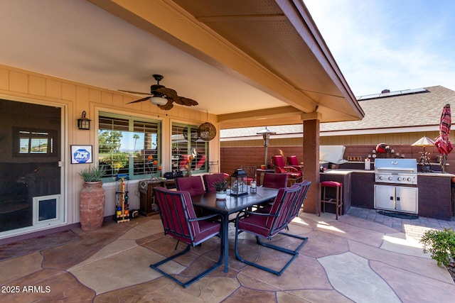 view of patio with grilling area, area for grilling, a ceiling fan, outdoor dining space, and fence