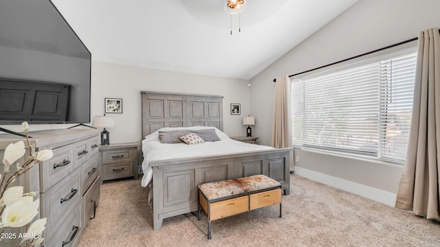 bedroom featuring vaulted ceiling, light colored carpet, a ceiling fan, and baseboards