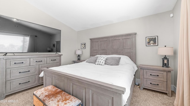bedroom featuring light colored carpet and vaulted ceiling