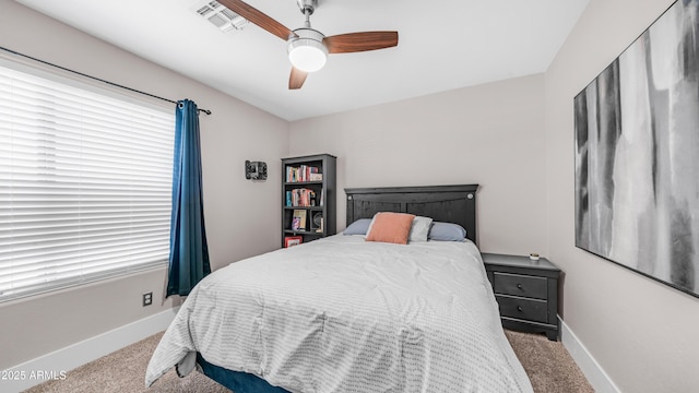bedroom with carpet floors, baseboards, a ceiling fan, and multiple windows