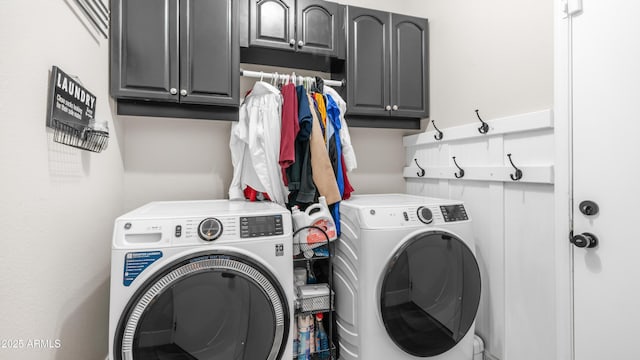 laundry area with washer and clothes dryer and cabinet space
