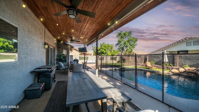 view of pool with ceiling fan, a fenced backyard, and a patio area
