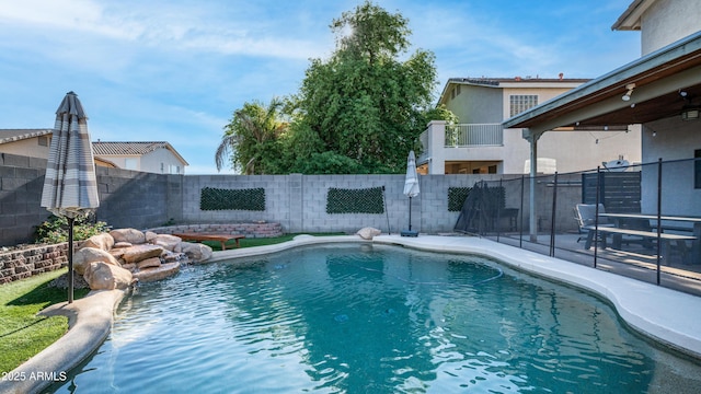 view of pool with a fenced backyard