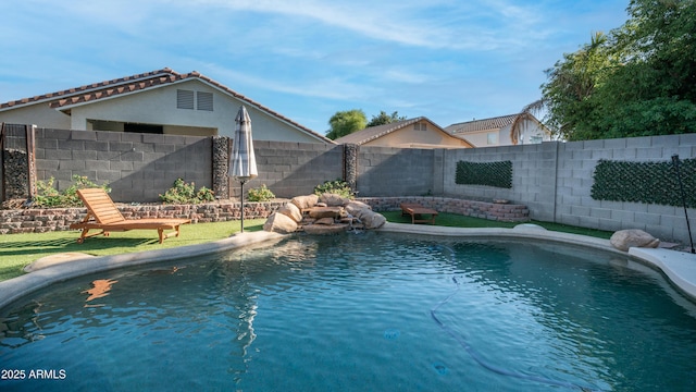view of pool with a fenced backyard