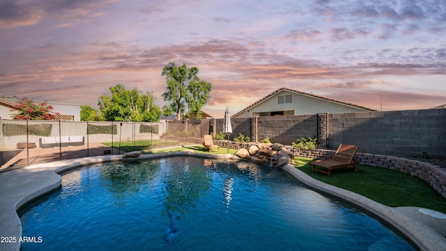 view of swimming pool featuring a fenced backyard