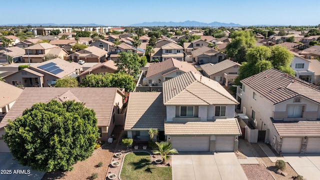 aerial view of residential area featuring a mountainous background
