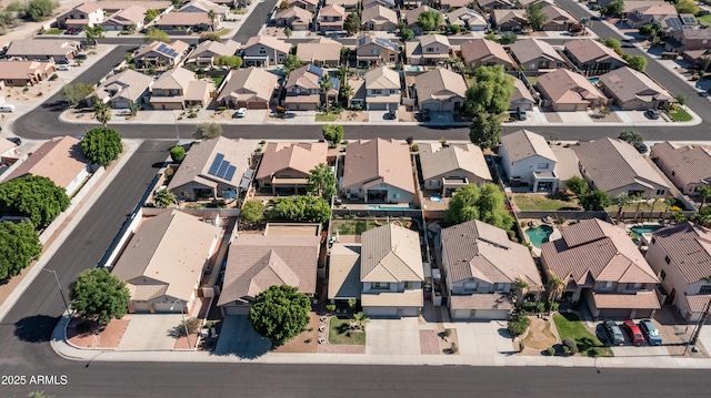 aerial view of property and surrounding area featuring nearby suburban area