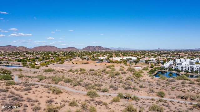 mountain view featuring a large body of water, nearby suburban area, and a desert landscape