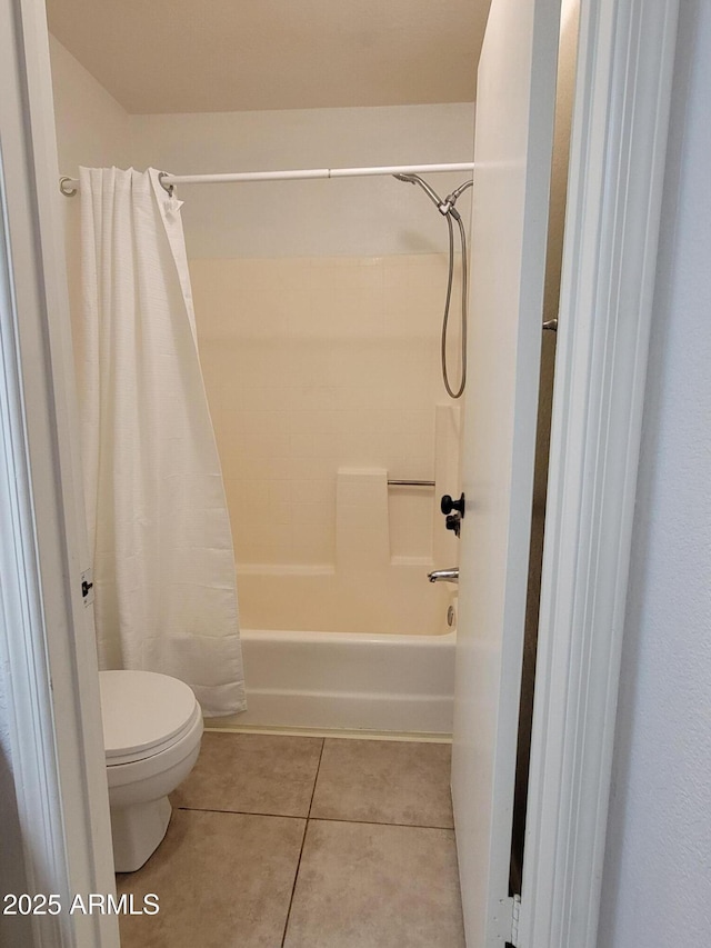 full bath with shower / bath combination with curtain, tile patterned flooring, and toilet