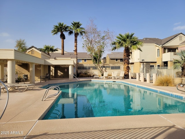 pool featuring a patio area and fence