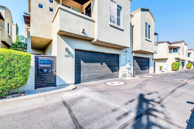 view of front of home featuring a garage and a balcony