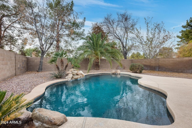 view of swimming pool with pool water feature