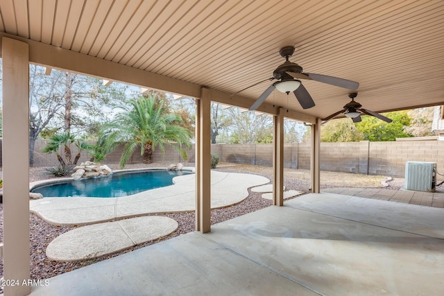 view of pool with central AC, ceiling fan, and a patio area