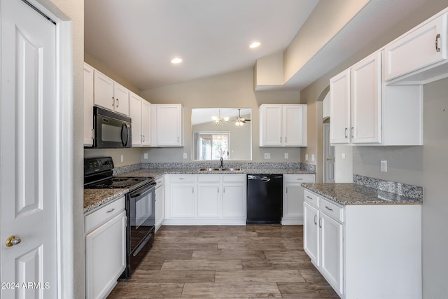 kitchen with lofted ceiling, black appliances, white cabinets, sink, and light hardwood / wood-style floors