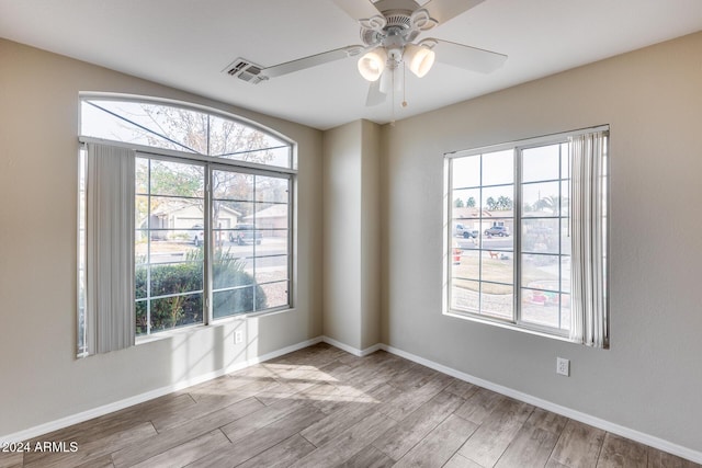 empty room featuring ceiling fan and light hardwood / wood-style floors